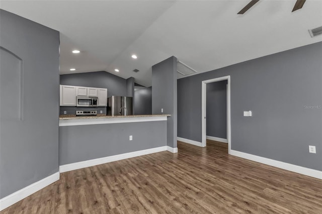 kitchen with white cabinetry, lofted ceiling, ceiling fan, kitchen peninsula, and stainless steel appliances