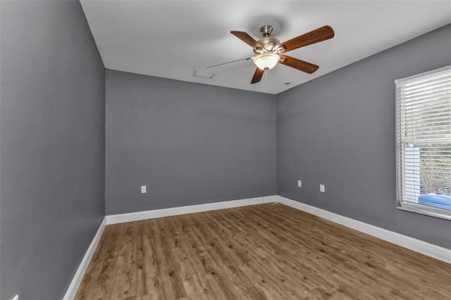 unfurnished room with hardwood / wood-style flooring, a wealth of natural light, and ceiling fan