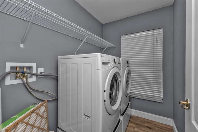 laundry area with wood-type flooring and independent washer and dryer