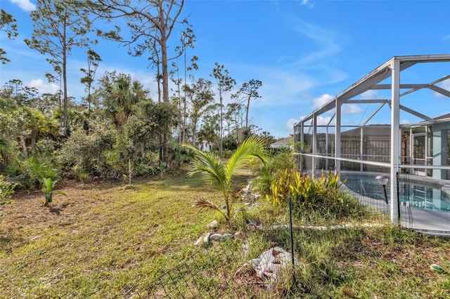 view of yard featuring glass enclosure