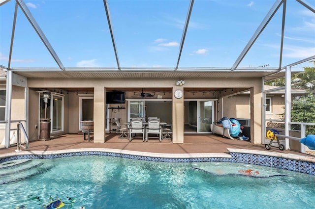 back of house featuring a patio, glass enclosure, and ceiling fan