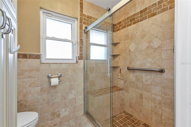 bathroom with toilet, walk in shower, and tile walls