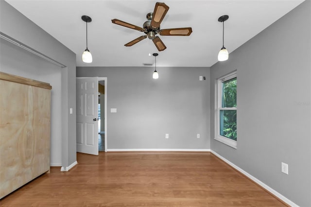 unfurnished room with ceiling fan and hardwood / wood-style floors