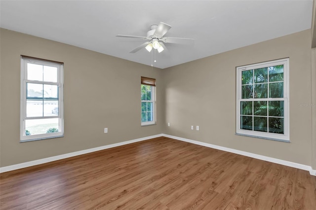 empty room featuring light hardwood / wood-style floors, a wealth of natural light, and ceiling fan