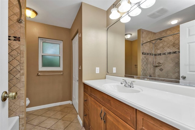 bathroom with toilet, vanity, and tile patterned floors