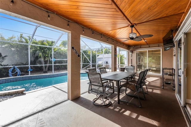 sunroom with ceiling fan, a swimming pool, and wooden ceiling