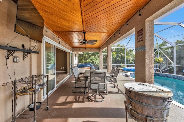 unfurnished sunroom with ceiling fan, a pool, and wood ceiling