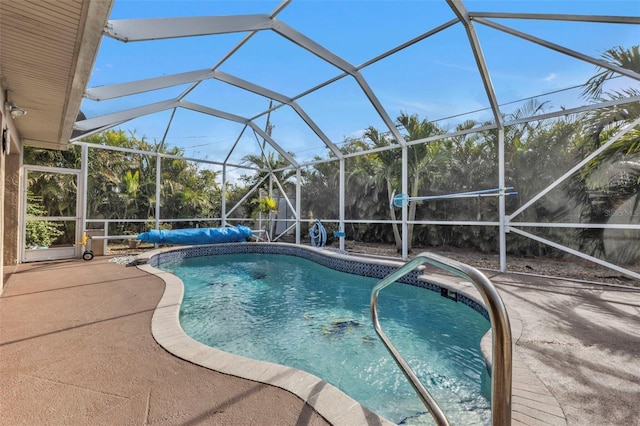 view of pool with a patio area and a lanai