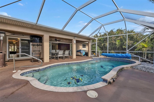 view of swimming pool featuring ceiling fan, a patio, and glass enclosure