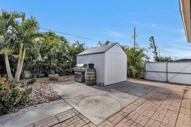 view of patio / terrace featuring a storage shed and grilling area