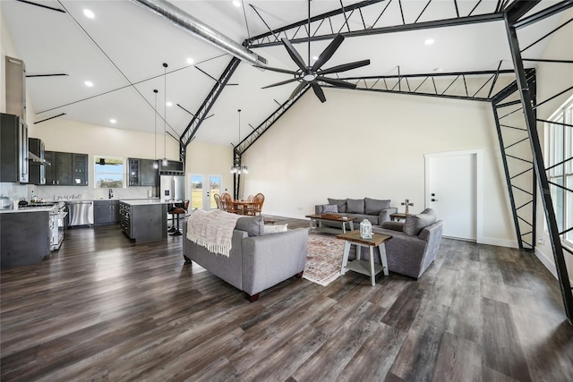 living room with dark hardwood / wood-style flooring, high vaulted ceiling, ceiling fan, and sink