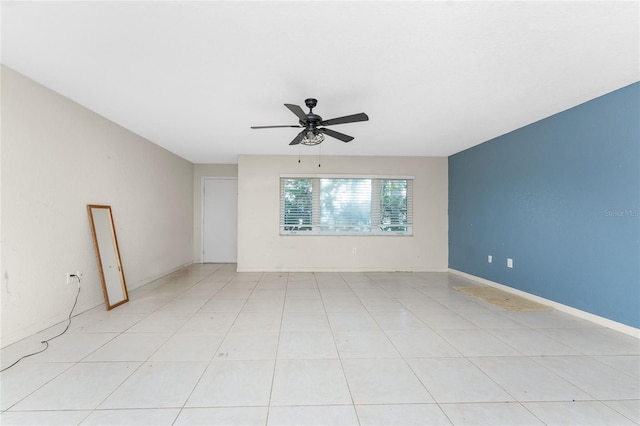 tiled spare room with ceiling fan