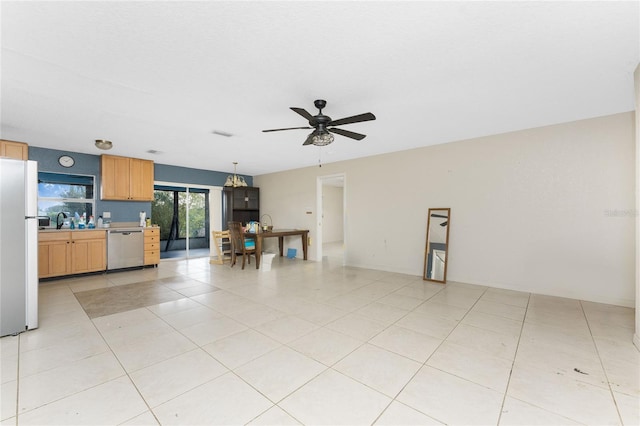 tiled living room featuring ceiling fan and sink