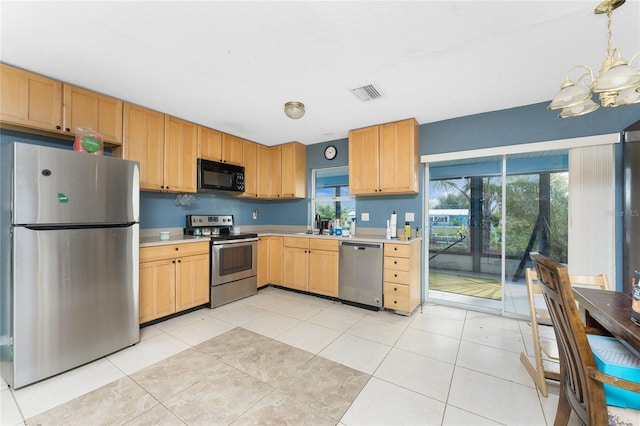 kitchen featuring pendant lighting, light brown cabinets, light tile patterned flooring, stainless steel appliances, and a chandelier