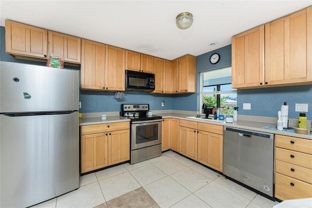 kitchen featuring light tile patterned floors, sink, and appliances with stainless steel finishes