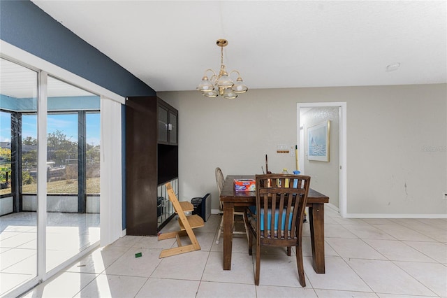 tiled dining area featuring a chandelier