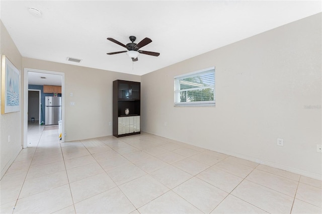 unfurnished room featuring light tile patterned floors and ceiling fan