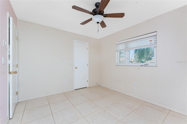 unfurnished room with a textured ceiling, ceiling fan, and light tile patterned flooring