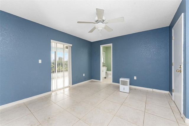 spare room with light tile patterned floors and ceiling fan