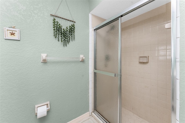 bathroom featuring a shower with door