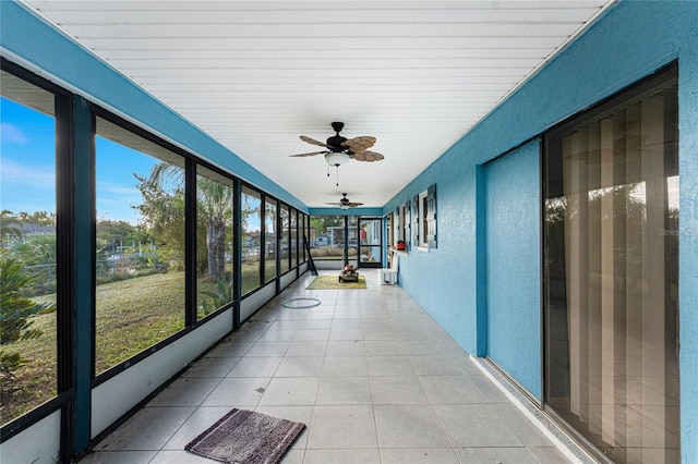 unfurnished sunroom with a wealth of natural light and ceiling fan