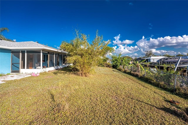 view of yard with a sunroom