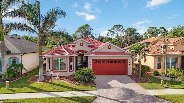 mediterranean / spanish home featuring a garage and a front lawn