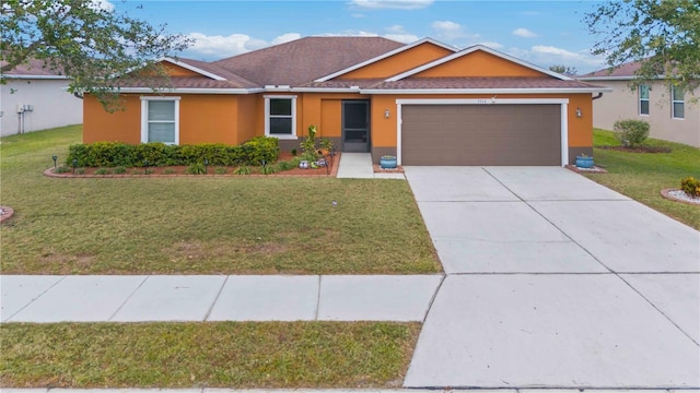 ranch-style house featuring a front lawn and a garage