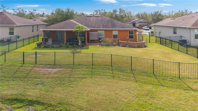 exterior space with central AC and a lawn