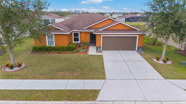 view of front of property featuring a garage and a front lawn