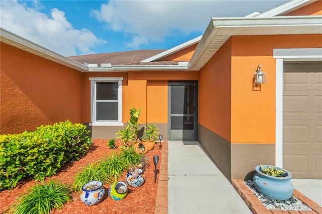 view of exterior entry with a garage