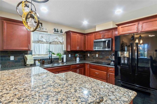 kitchen with tasteful backsplash, sink, black appliances, and stone countertops