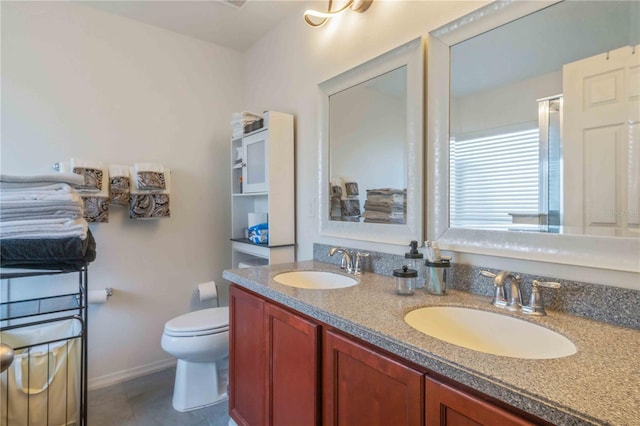 bathroom with tile patterned flooring, vanity, and toilet