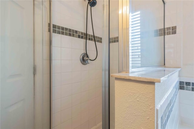 bathroom with a tile shower and tile walls