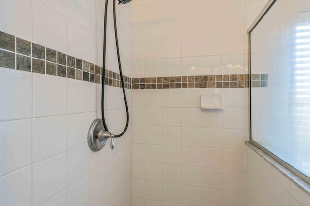 bathroom with a tile shower