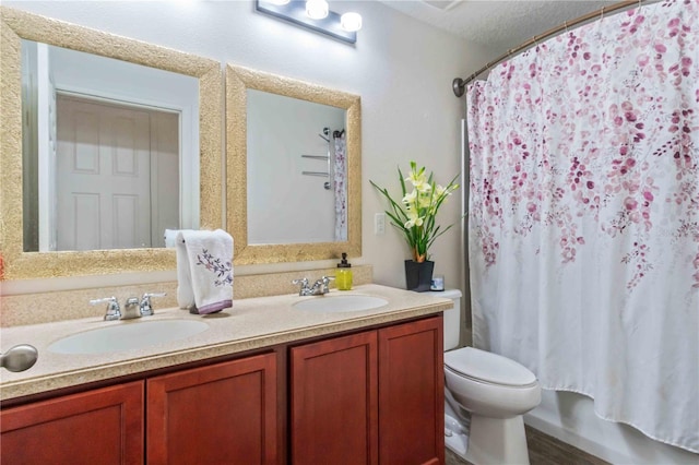 full bathroom with shower / tub combo, a textured ceiling, vanity, hardwood / wood-style floors, and toilet