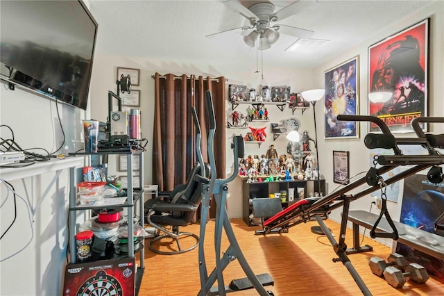 exercise area featuring ceiling fan and hardwood / wood-style flooring