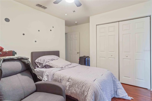 bedroom with a closet, ceiling fan, and dark wood-type flooring