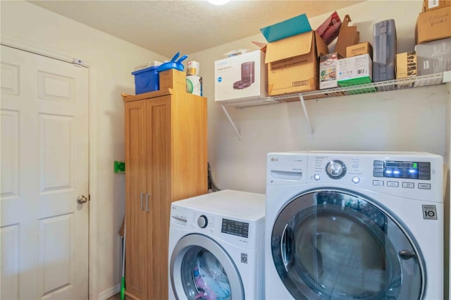 washroom featuring cabinets, separate washer and dryer, and a textured ceiling