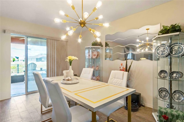 dining area featuring hardwood / wood-style floors and an inviting chandelier