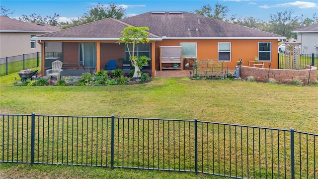 back of house featuring a lawn and a patio area