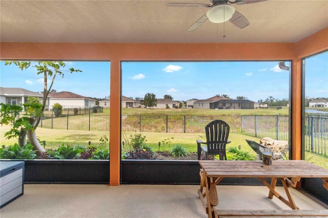 sunroom featuring ceiling fan