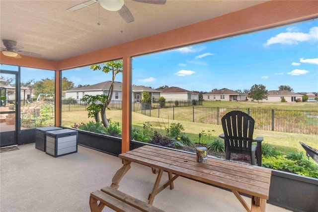 sunroom featuring ceiling fan