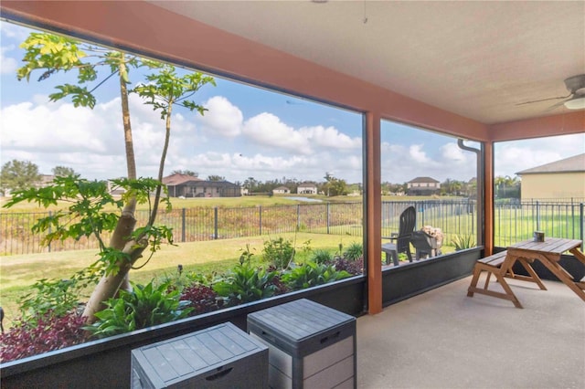 sunroom featuring ceiling fan