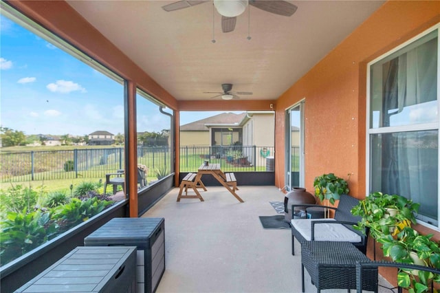 sunroom featuring ceiling fan