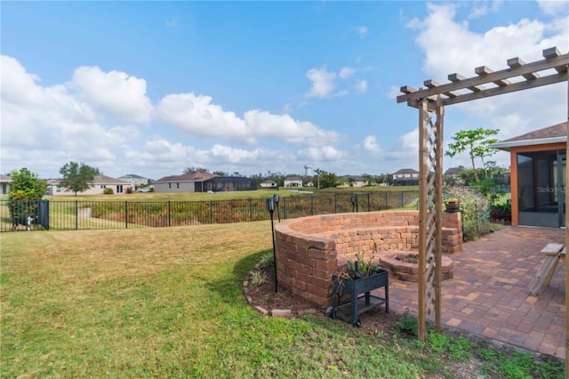 view of yard featuring a fire pit, a sunroom, and a patio area