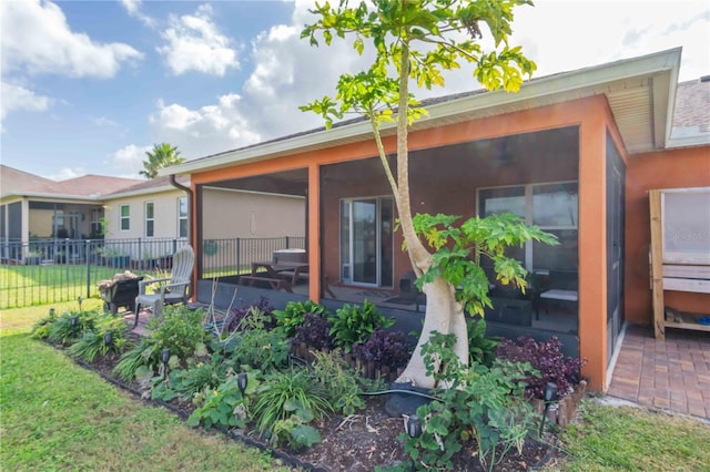 rear view of house featuring a patio and a lawn