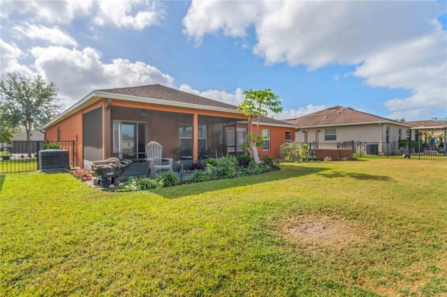 back of house featuring a lawn, a sunroom, and cooling unit