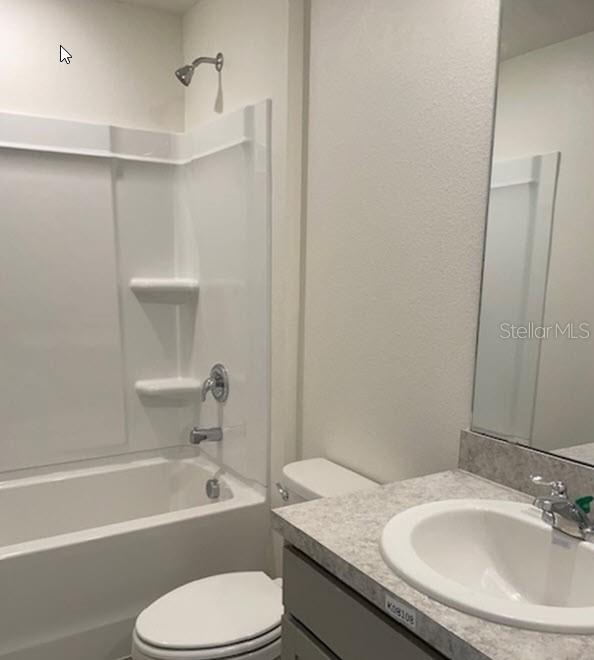 full bathroom featuring vanity, shower / bathing tub combination, and toilet