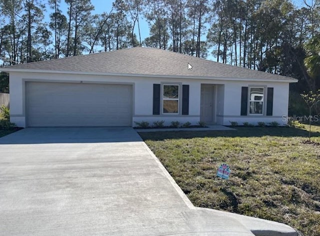 ranch-style home featuring a garage and a front lawn